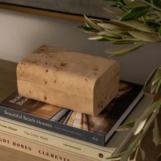 A wooden box on a stack of coffee table books from McGee & Co.