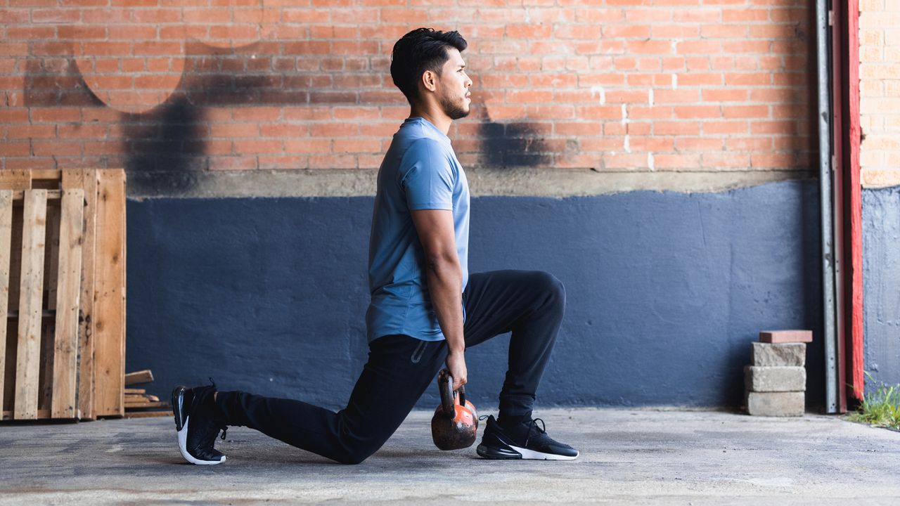 Man performing kettlebell lunges