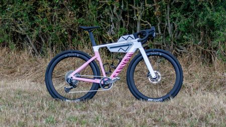 A pink and white Canyon Grail CF SLX in a field 