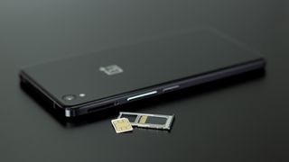 A SIM card next to a OnePlus phone