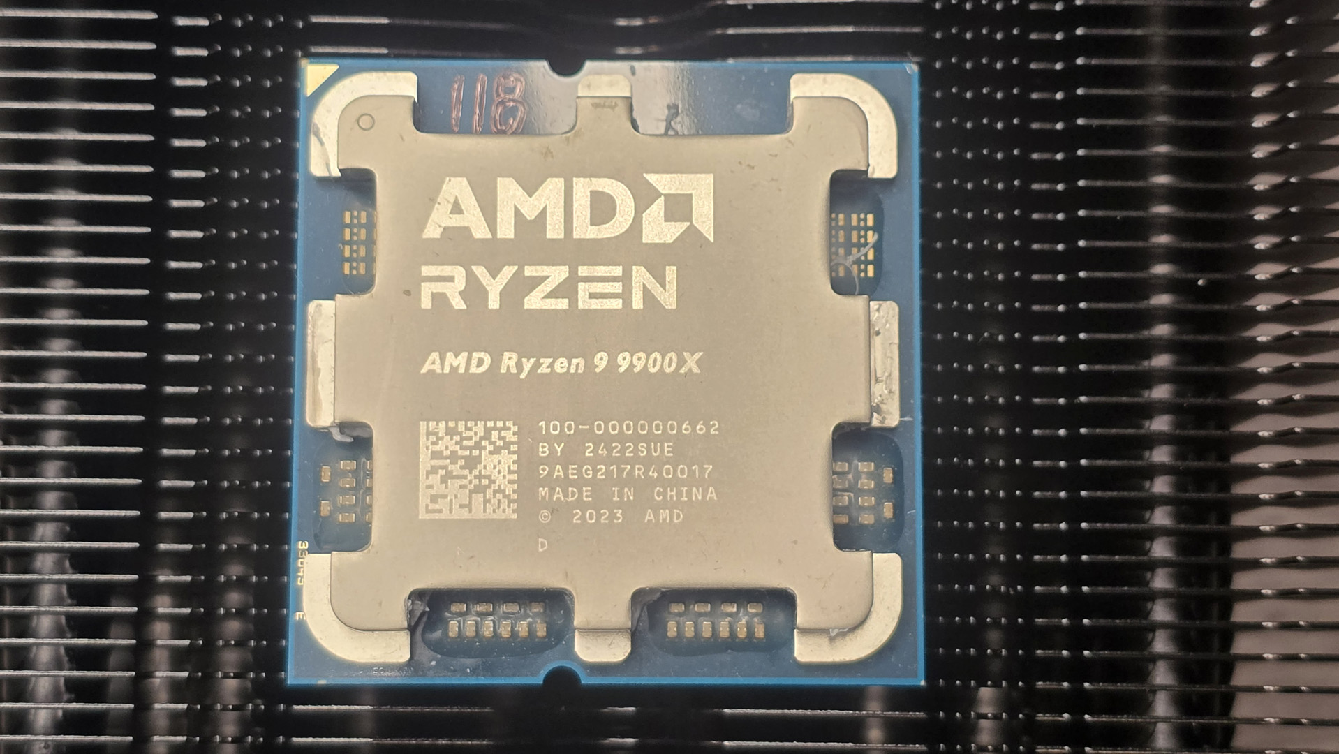 The AMD Ryzen 9 9900X CPU lying on a cooling vent