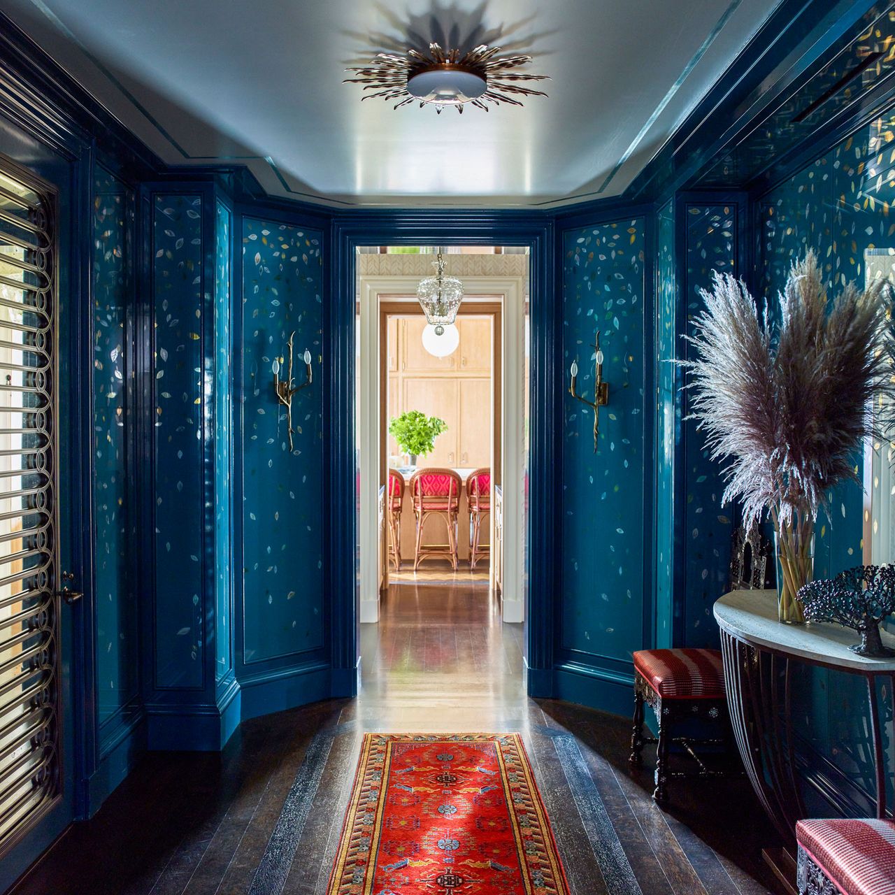 Blue hallway with falling leaves design, gold sunshine light