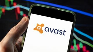 Avast Software logo seen displayed on a smartphone with an economic stock exchange index graph in the background