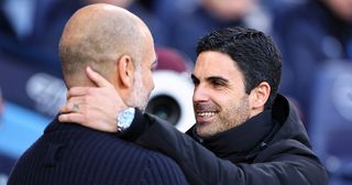 Manchester City and Arsenal managers Pep Guardiola and Mikel Arteta respectively embrace during the Premier League match between Manchester City and Arsenal FC at Etihad Stadium on April 26, 2023 in Manchester, United Kingdom.