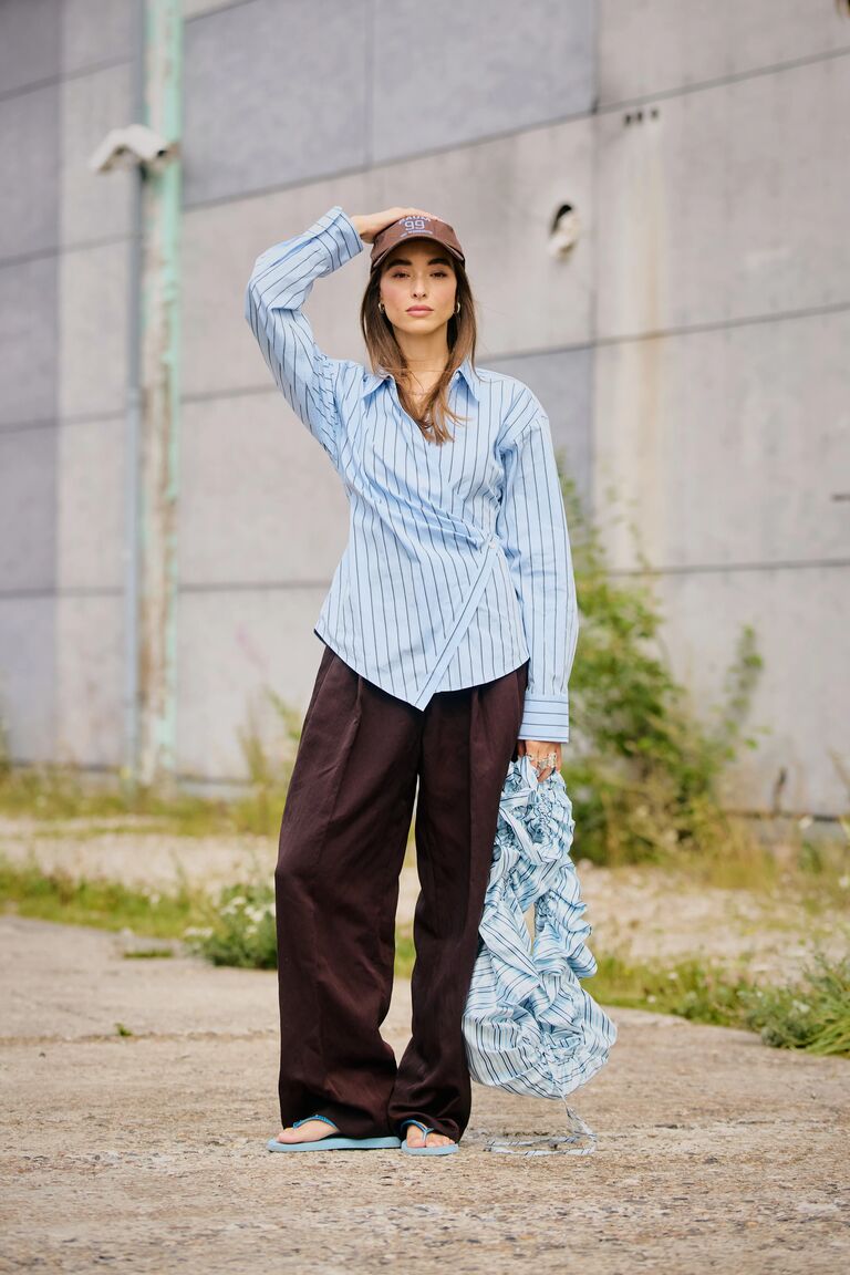 Woman in blue shirt and brown pants
