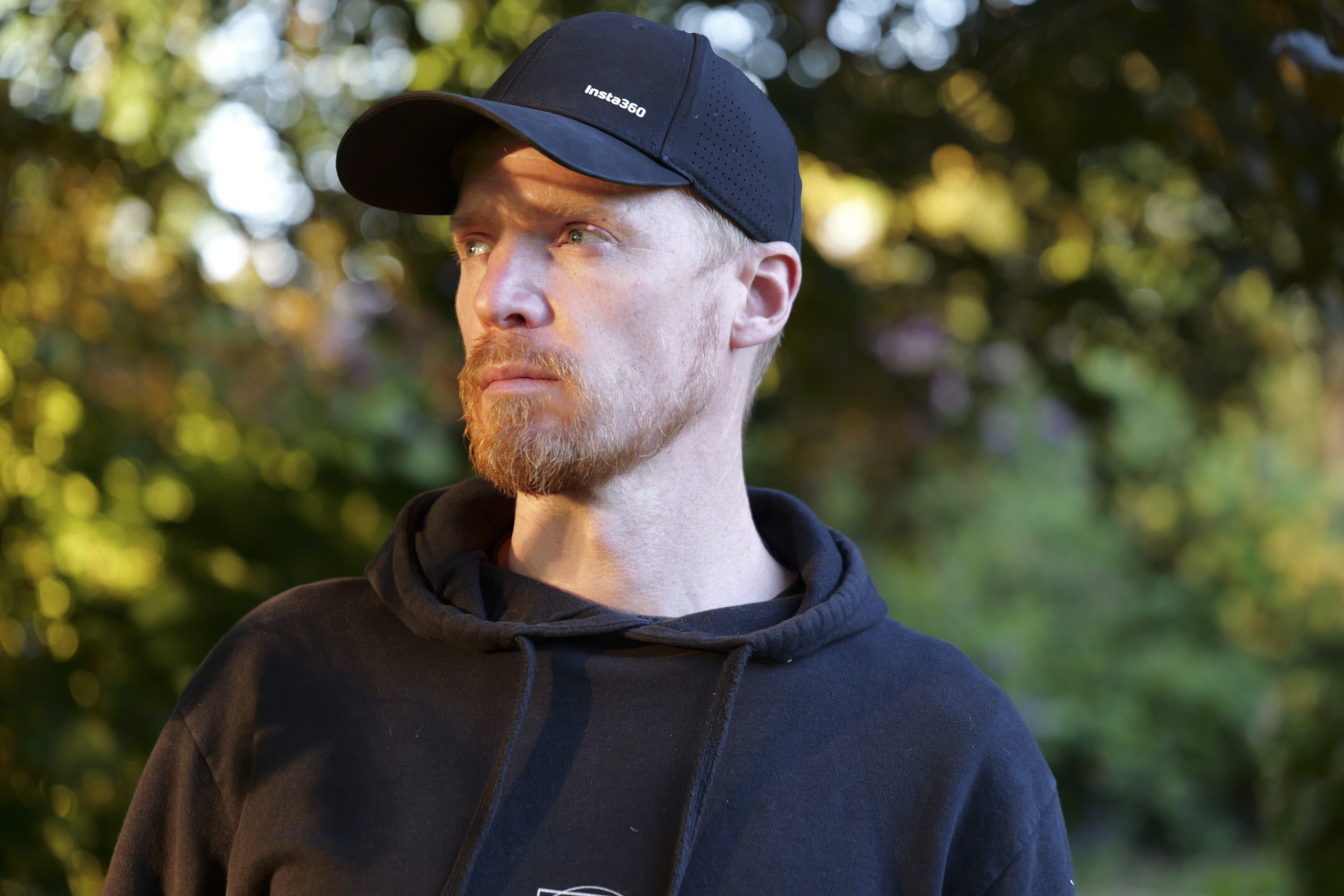 Panasonic Lumix S1 II image gallery: male portrait at golden hour, among trees, dappled light