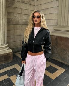 woman wearing pink set and leather jacket