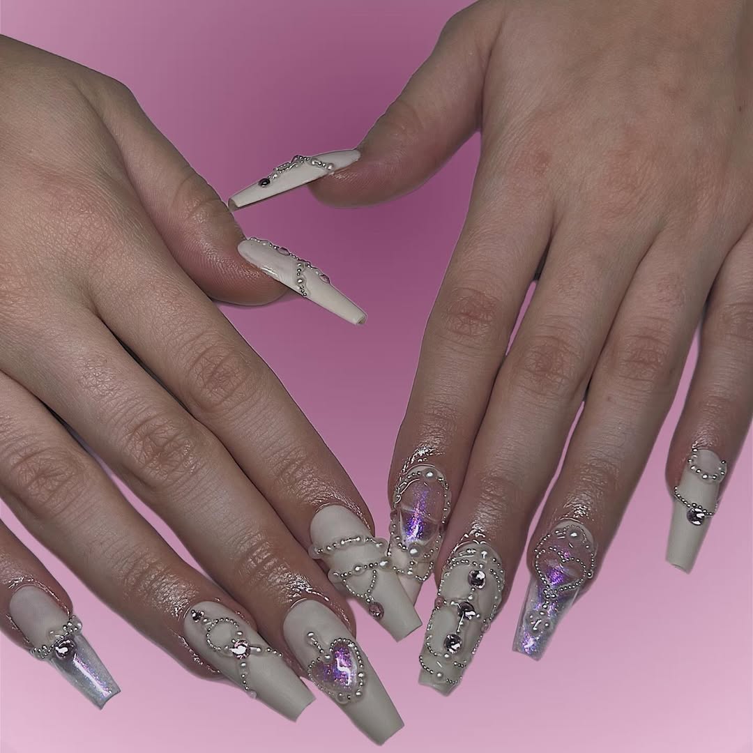 matte white coffin nails with silver and pearl decorations