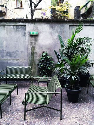 Garden courtyard with green benches