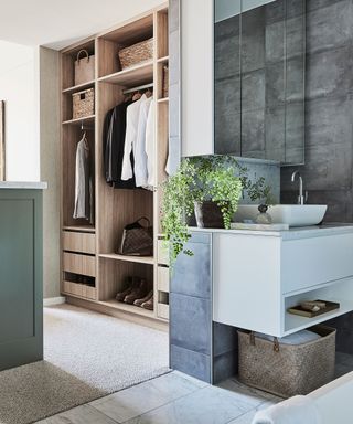 Open walk-in closet ideas flowing out from a contemporary bathrom, with wood and slate accents.