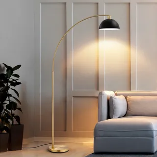 an arched gold floor lamp in a neutral living room