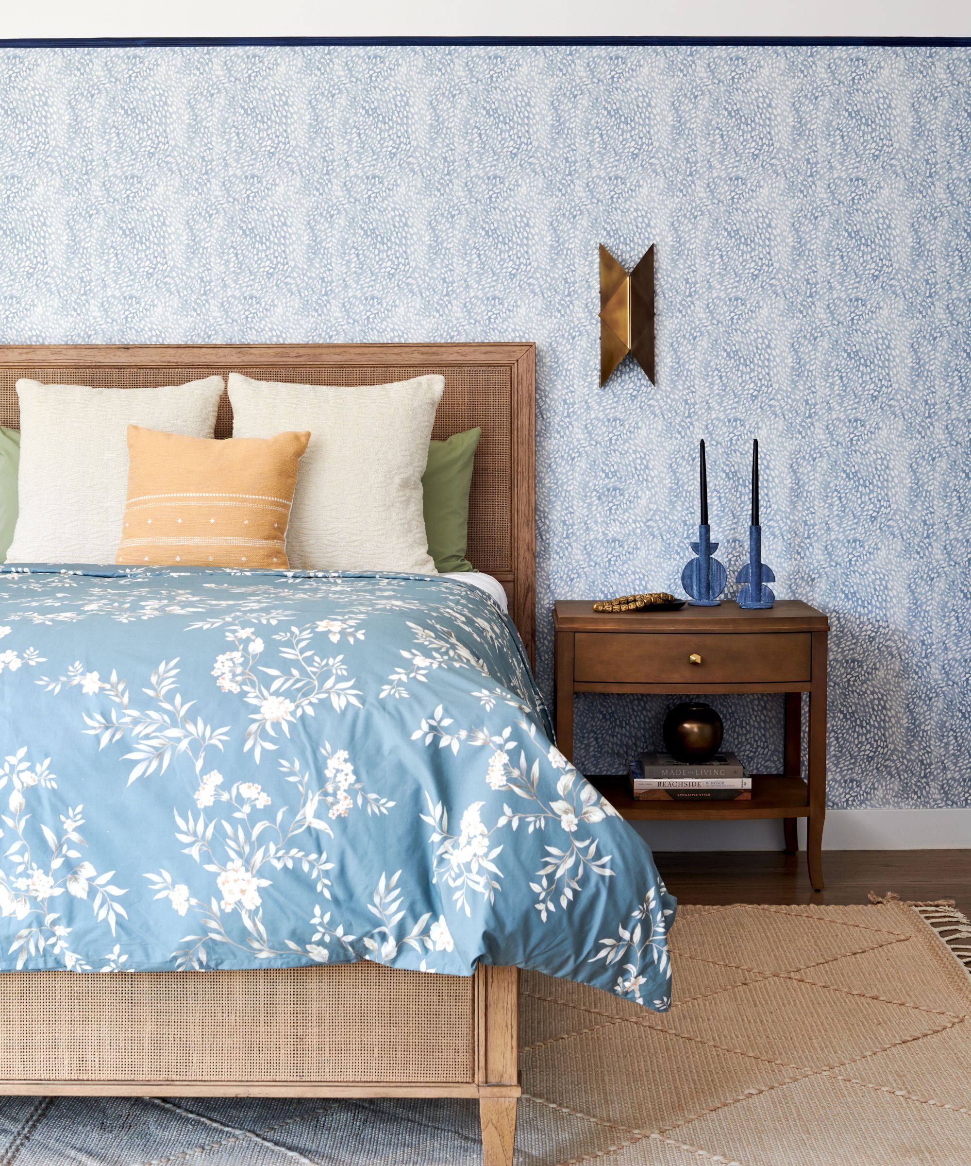coastal bedroom with blue and white wallpapers and wooden furnishings