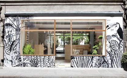 Shop with a black and white tropical rainforest front