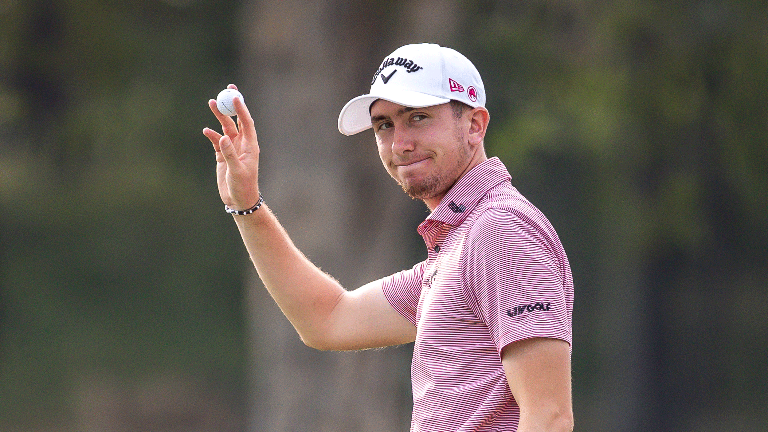 Tom McKibbin smiles and holds his golf ball up to the crowd during the final round of the 2025 Hong Kong Open