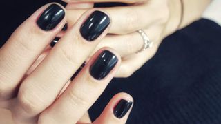 Hands with black nail polish