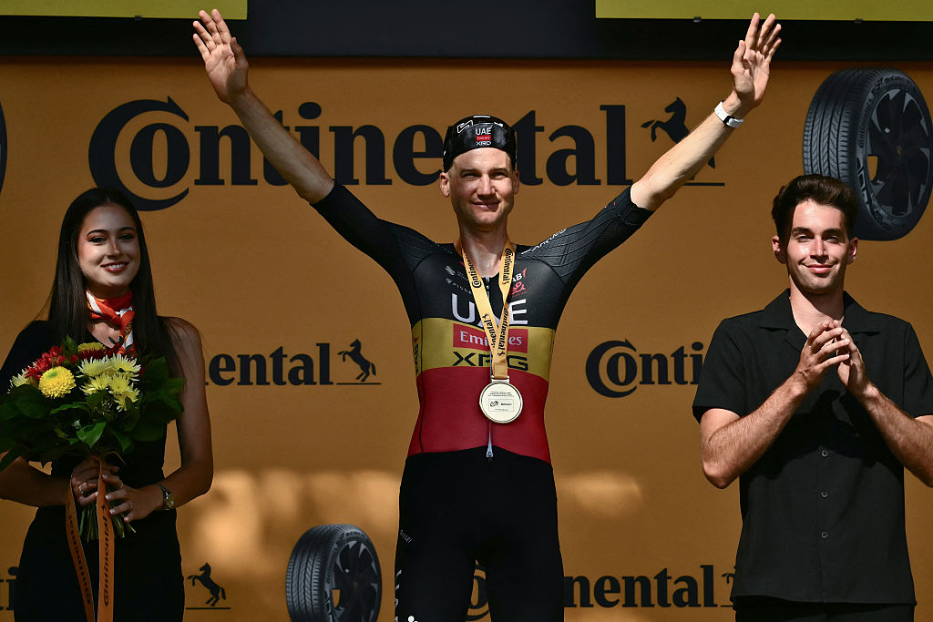 UAE Team Emirates - XRG team's Belgian rider Tim Wellens celebrates on the podium after winning the 15th stage of the 112th edition of the Tour de France cycling race, 169.3 km between Muret and Carcassonne, southwestern France, on July 20, 2025. (Photo by Marco BERTORELLO / AFP)