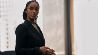 Yaya DaCosta as Andrea standing in front of an office window in The Lincoln Lawyer season 2