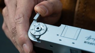 The Fujifilm X Half retro compact camera in a person's hands