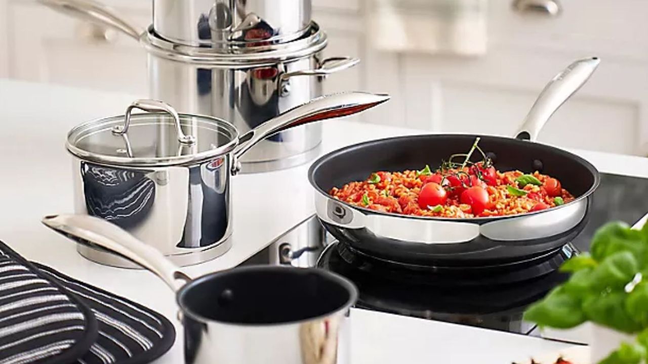 Lakeland 5-piece Stainless Steel Pan Set being used on an induction hob - the frying pan has a risotto on