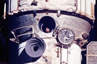 Cosmonaut Valeri Polyakov looks out the Russian space station Mir's window during his record-setting 438-day mission from 1994 to 1995.