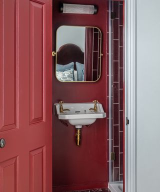 shower room with dark red walls and door