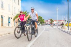 Two people riding e-bikes