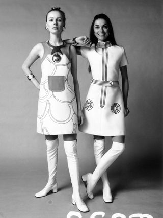 29th January 1970: Two models wearing white gaberdine dresses and matching white boots.