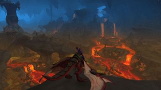 WoW 10.1 update - a shadow priest sitting on a dragonriding mount looks out over rivers of lava inside a huge cavern