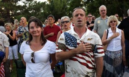 Arizona conservatives sing the national anthem at a rally against illegal immigration in Phoenix, Arizona.