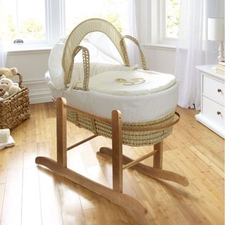 Little Rocker Moses Basket in white children's room with wooden floors