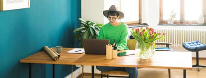 Businesswoman in home office working at her laptop