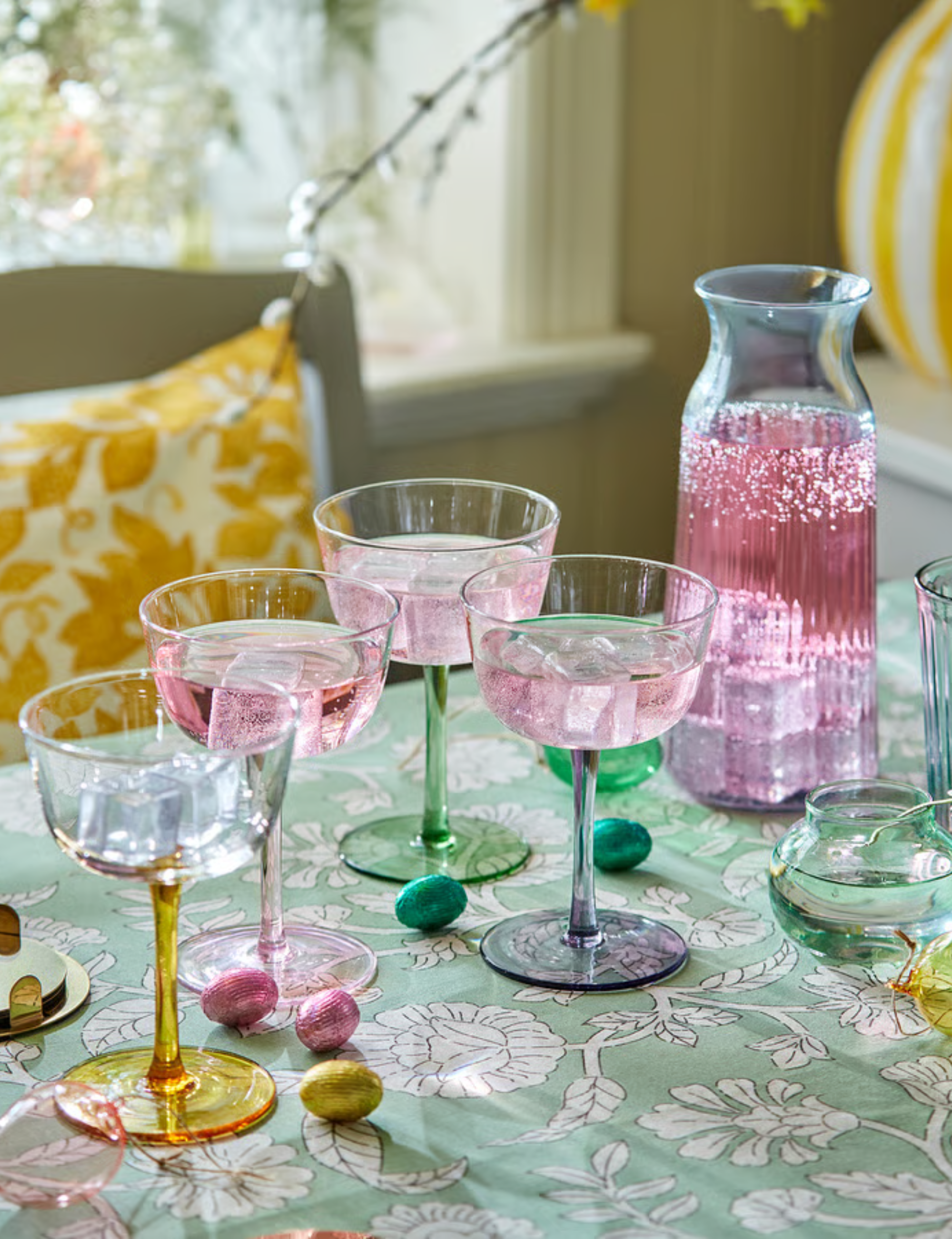 Floral tablescape vignette featuring multi-color pastel cocktail coupes