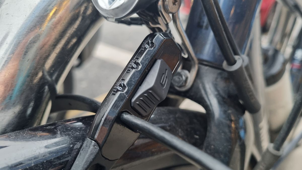 A Hiplok Z Lok Combo securing the front wheel of a road bike to a Sheffield stand