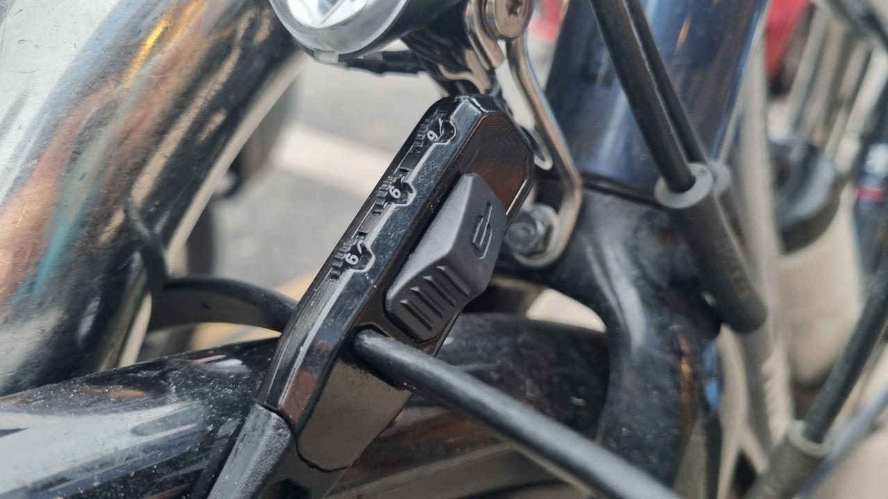 A Hiplok Z Lok Combo securing the front wheel of a road bike to a Sheffield stand