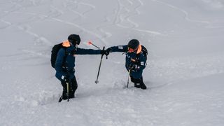 Two skiers high fiving
