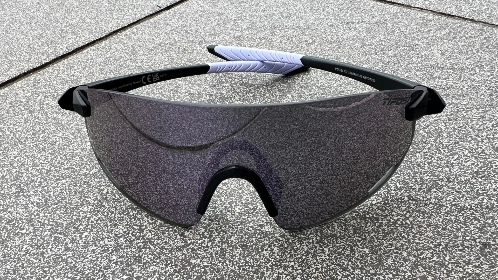 The Tifosi Vogel XC Sunglasses on a grey tile