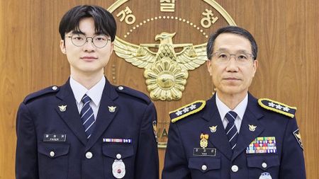 Faker in his Korean National Policy Agency uniform, standing next to another Korean National Policy Agency officer