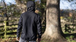 Albion Zoa Rain Shell jacket with the large hood pulled up shot from behind