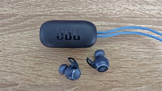 JBL Reflect Aero review: chargihng case with strap and two earbuds blue