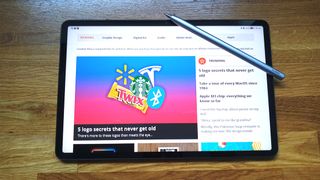 A photo of a tablet on a wooden table, it's screen is very bright