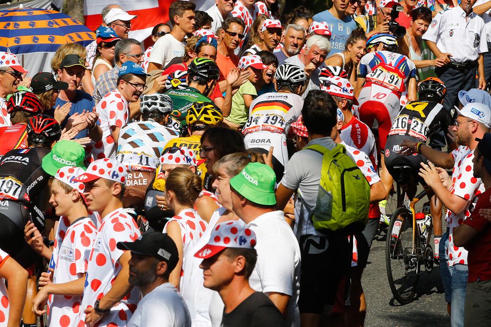 The peloton makes its way through the Tour de France crowds.