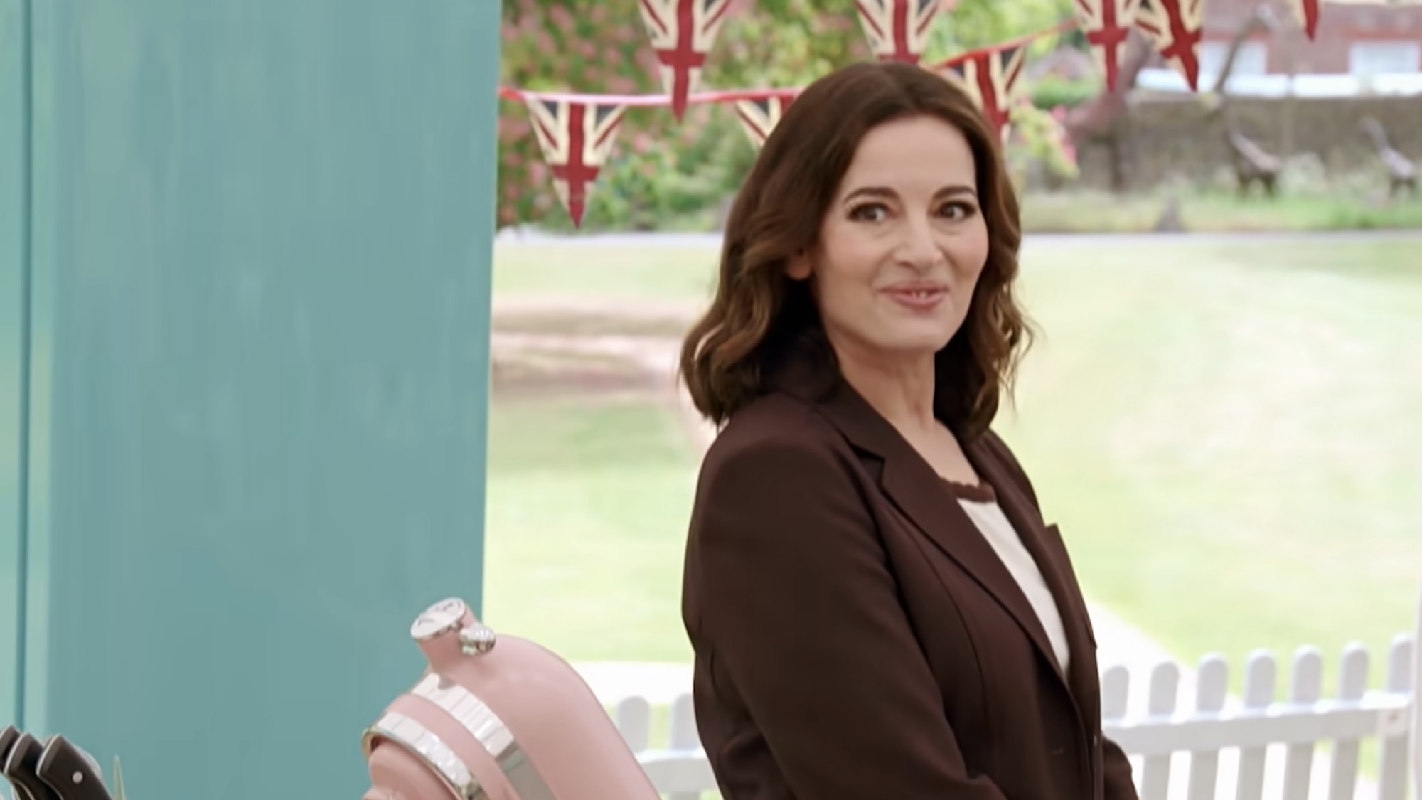 Nigella smiling in a brown blazer in the trailer for Bake Off.