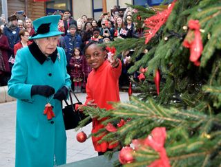 Queen Elizabeth looking at a Christmas tree