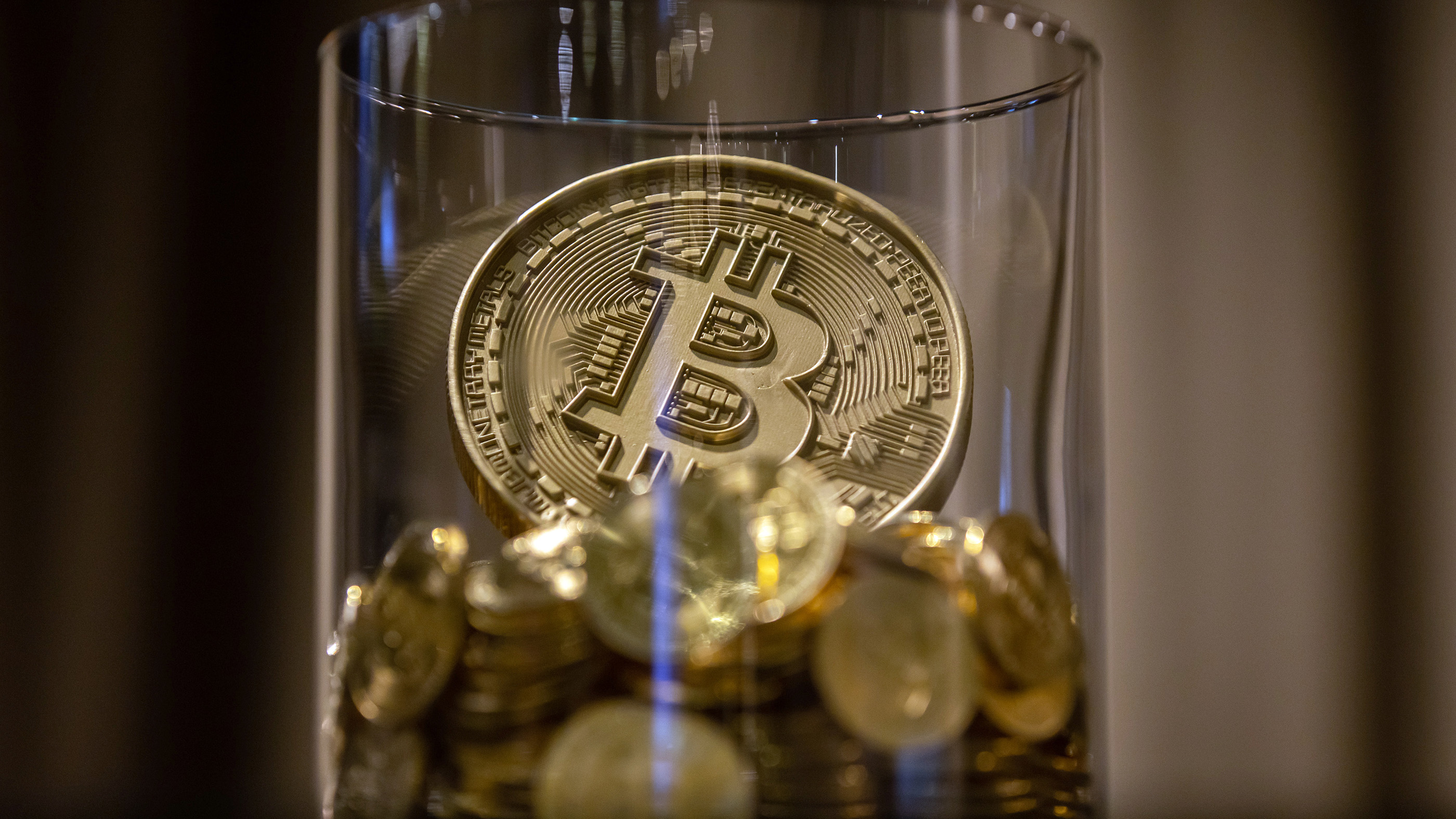 A novelty Bitcoin token arranged at a CoinUnited cryptocurrency exchange in Hong Kong, China, on Friday, March 4, 2022.