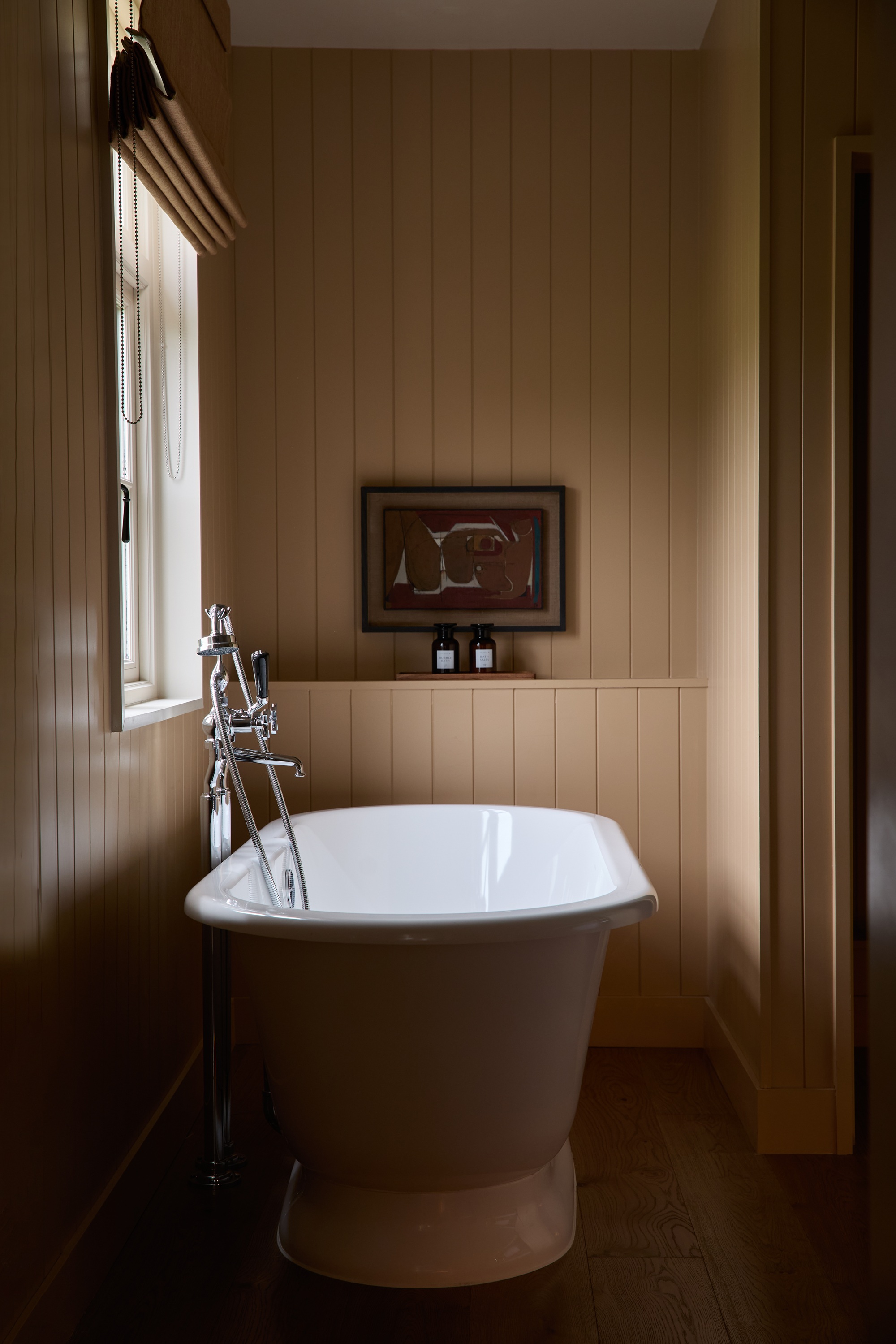 a bathroom with beadboard panelling painted in a bright yellow