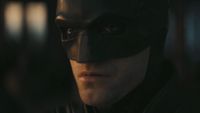Close-up of Batman in cowl watching the sunrise in The Batman