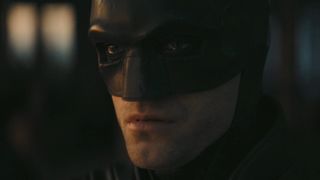 Close-up of Batman in cowl watching the sunrise in The Batman