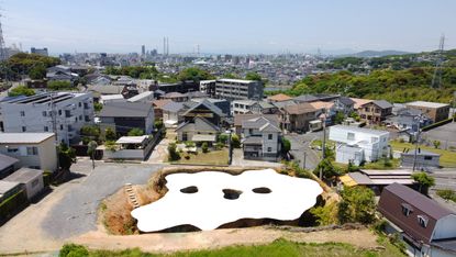 Aerial hero shot of white flowing structure in japan