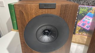 KEF Q Concerto Meta standmount speakers close up on drivers and showing KEF badge