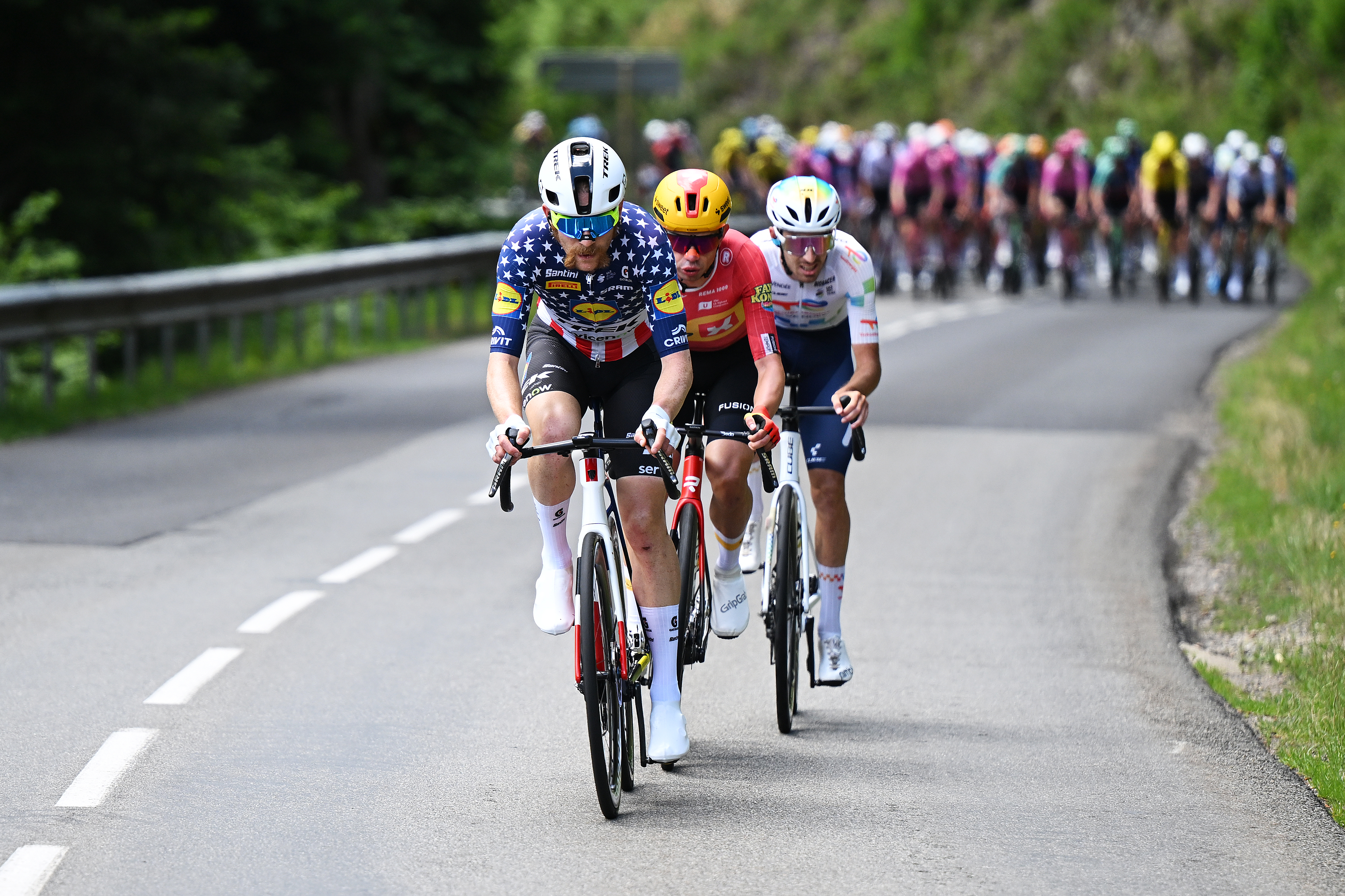 MONTROND-LES-BAINS, FRANCE - JUNE 10: (L-R) Quinn Simmons of United States and Team Lidl - Trek, Andreas Kron of Denmark and Team Uno-X Mobility and Jordan Jegat of France and Team TotalEnergies compete in the breakaway competes during the 78th Tour Auvergne-Rhone-Alpes 2026, Stage 4 a 167.4km stage from Le Puy-en-Velay to Montrond-les-Bains / #UCIWT / on June 10, 2026 in Montrond-les-Bains, France. (Photo by Dario Belingheri/Getty Images)